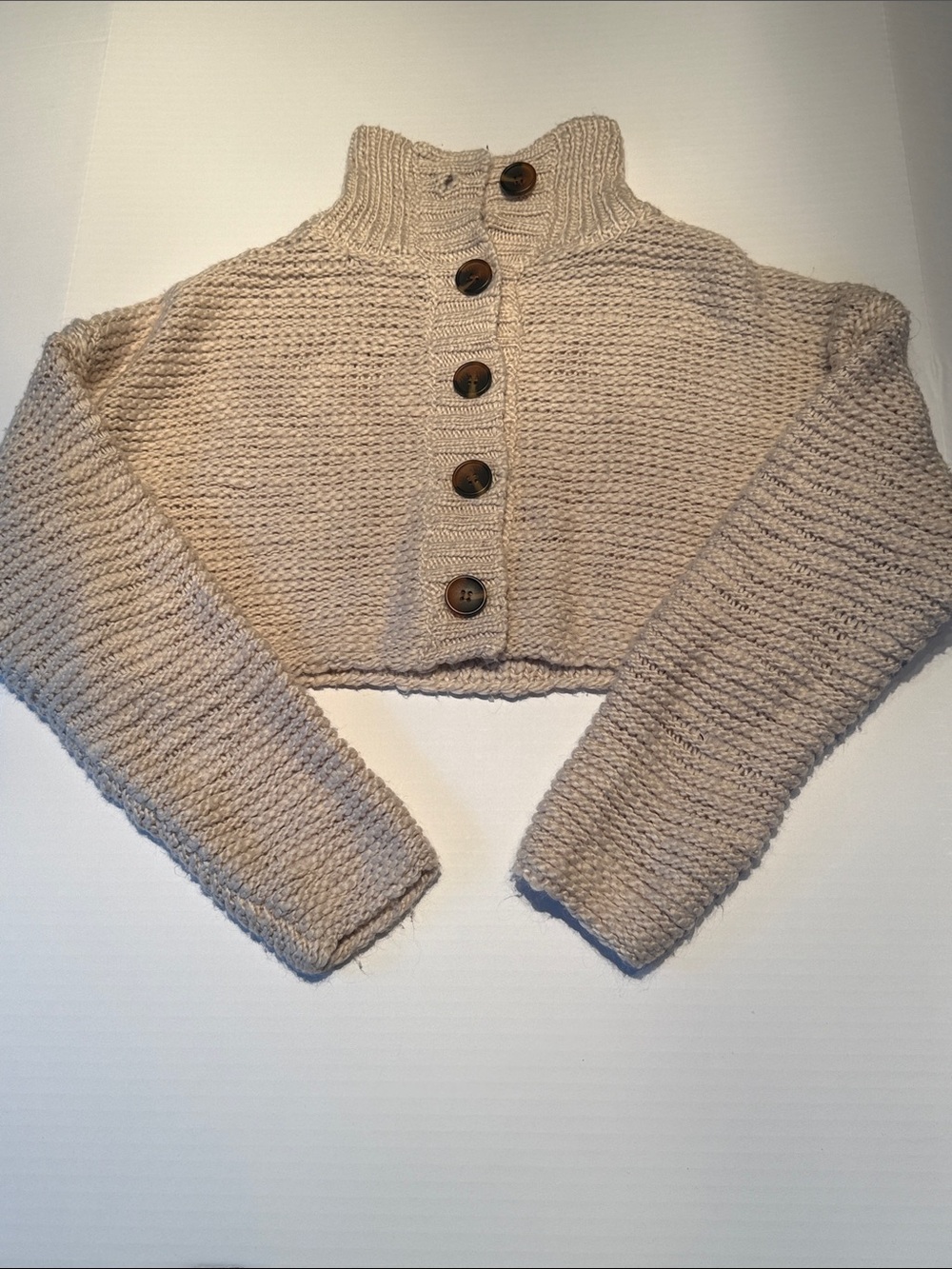 BDG Cropped Button-Front Knit Sweater in Beige. Loose fit